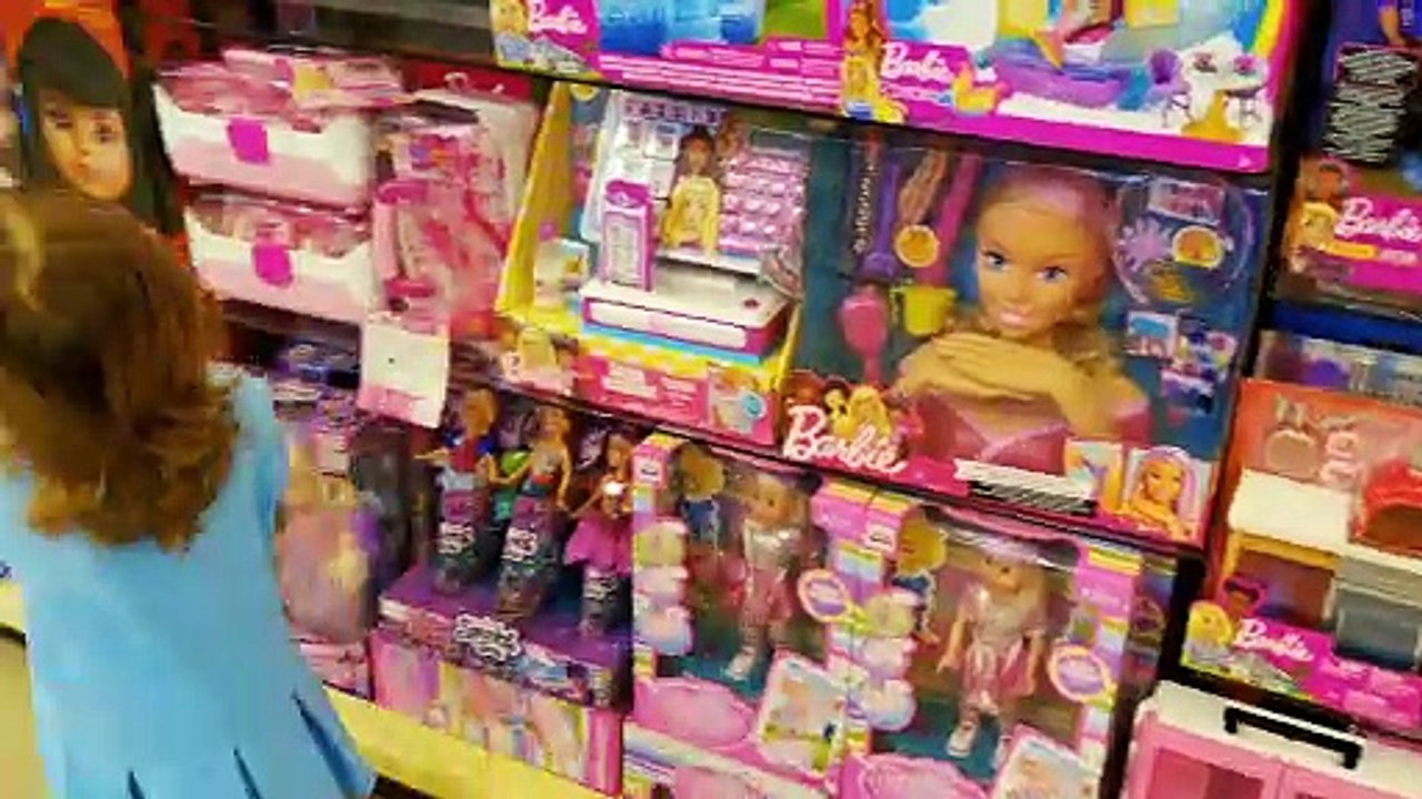 Little Mia is shopping in toy store in Dubai Mall and buying Barbie Doll. Playing with soap baubles