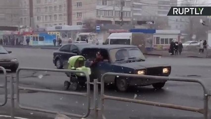 Baby Stroller Pulled Down City Street by Passenger in Moving Car