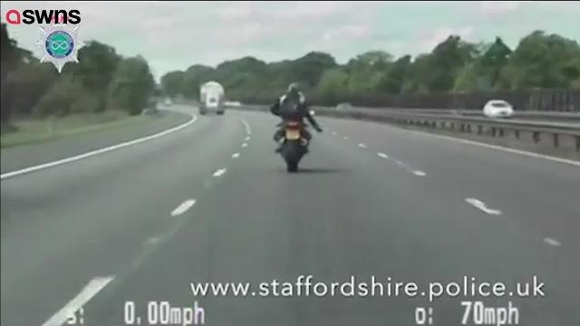 Wheelie stupid: The man stands up on the bike