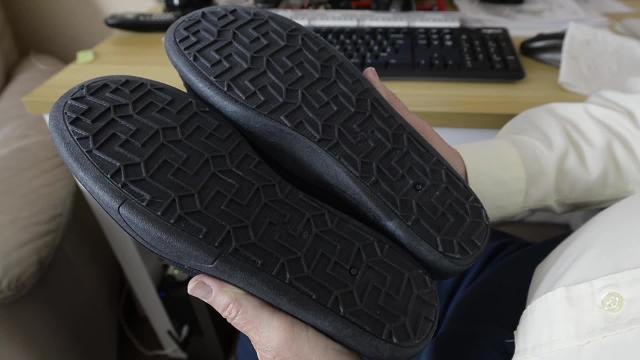 A furious pensioner has spoken of his shock after claiming his brand new slippers had swastikas all over the soles .