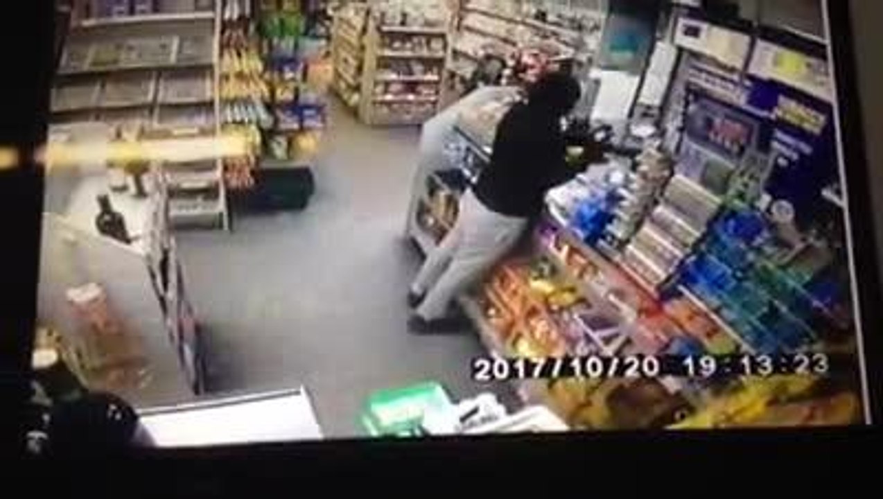 Armed robber points gun at terrified shop assistant