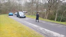 Trevor Howard's four Afghan Hounds lead the hearse out at his funeral at Burnley Crematorium.