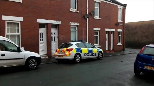 Police outside house where baby was found injured