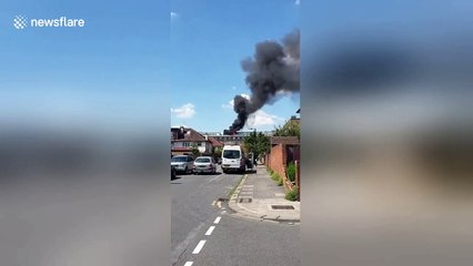 Thick smoke envelops London block of flats in east Acton