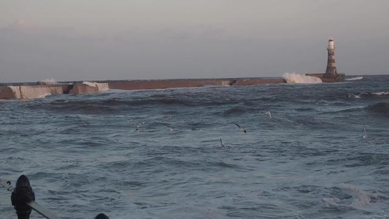 Waves crash against Roker Pier