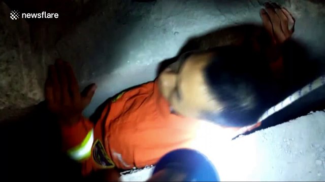 Chinese firefighters rescue girl trapped between walls after falling out of a flat