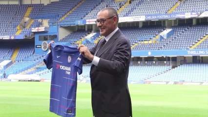 Maurizio Sarri Holds up Chelsea Shirt on Stamford Bridge Pitch