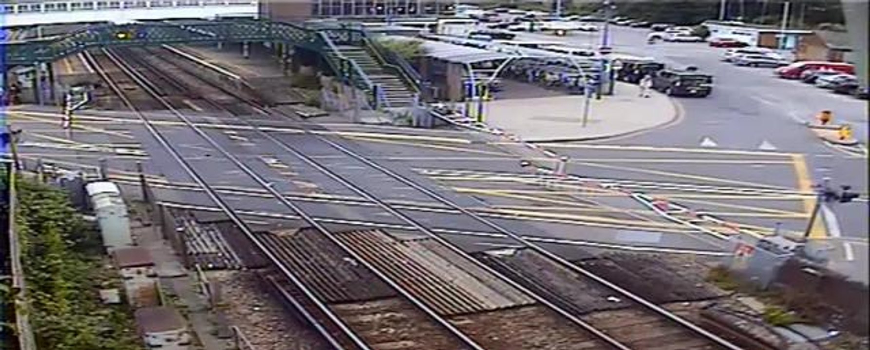 Driver smashes through level crossing