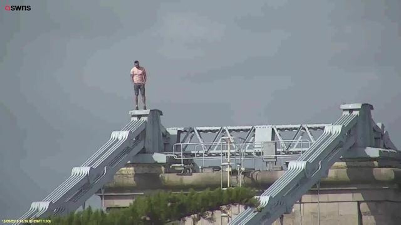 Drunk man climbs 150ft bridge to escape police...