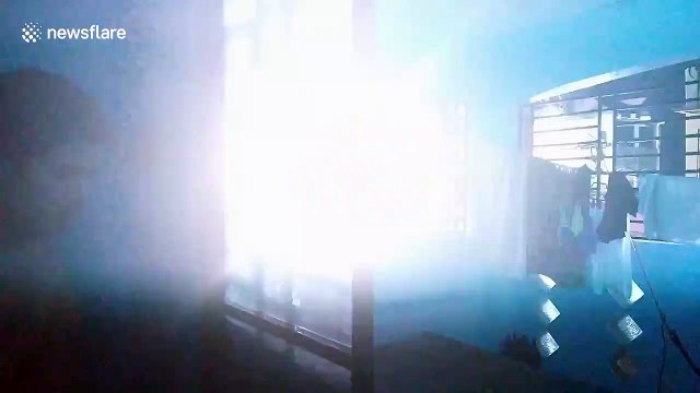 Terrifying moment power lines explode outside resident's bedroom window in the Philippines