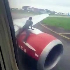 Man jumps on plane wing as it prepares for takeoff