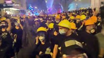 Hong Kong protesters create noise before a police push forces crowds back
