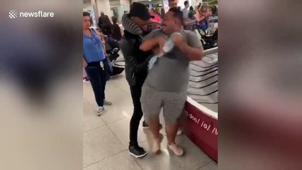 Man shoves larger friend into doing 'baggage claim surfing'