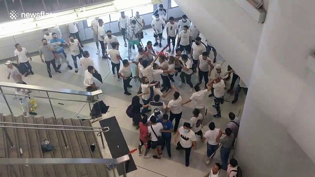 Moment lone woman is attacked with umbrella at Hong Kong station by thugs in white shirts