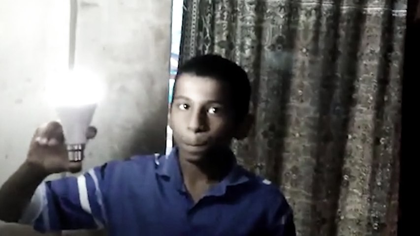 Boy lights LED bulb with bare hands