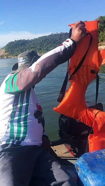 Men in Boat Rescue Monkey with Life Jacket