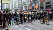 Black-clad protesters gather after Hong Kong police fired tear gas