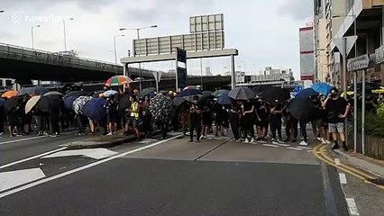 Tense standoff between Hong Kong protesters and police near China Liaison Office