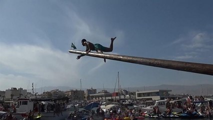 Daredevils scale greasy pole in bizarre traditional competition