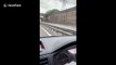 Rain floods two lanes on UK motorway during rush hour