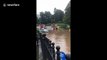 Emergency services use lifeboats to rescue stranded residents from flooding in Bramhall, Greater Manchester