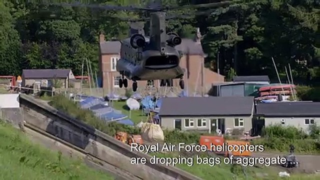 RAF, firefighters scramble to prevent English dam collapse