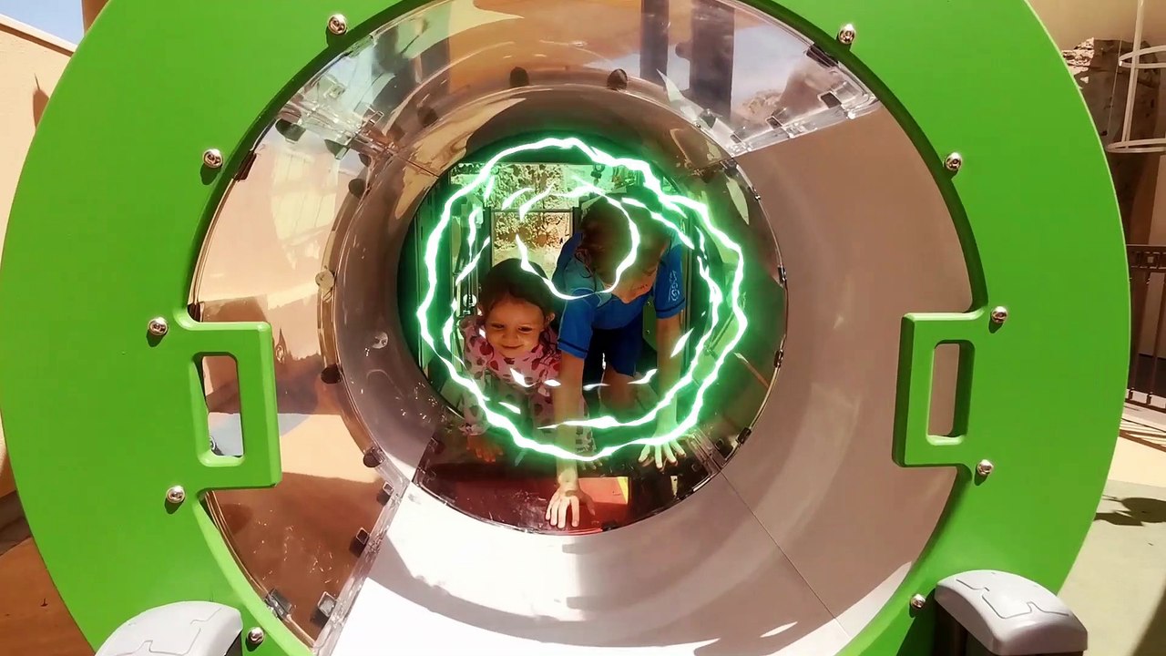 Little Mia and her brother playing in outdoor playground for children. Kids entertainment Part 2