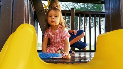 Little Mia playing with Elsa Doll from Frozen in Lava and waterfall on slide outdoor playing area