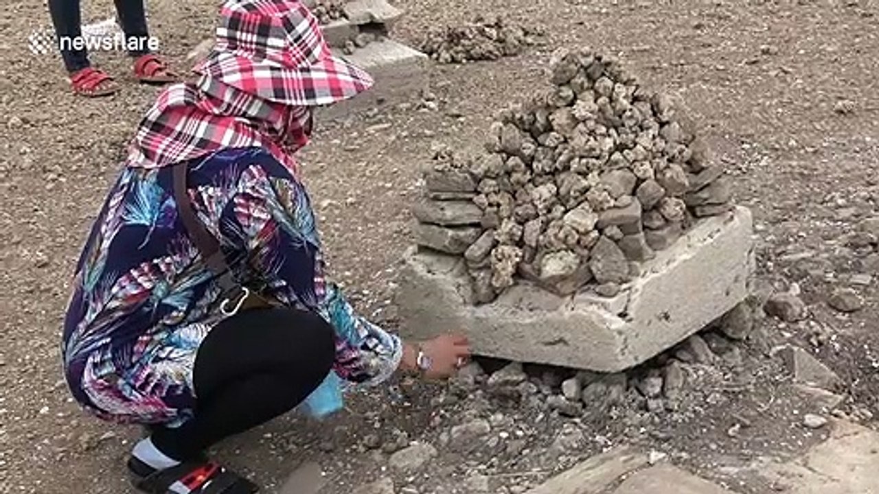 Thai locals flock to sunken Buddhist temple that has emerged from the water after severe drought