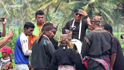This traditional form of Indonesian martial arts sees two people battle it out in a muddy rice field