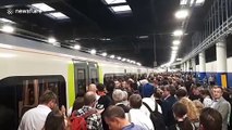 Long line of passengers wait to board train at Euston station in London