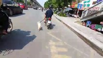 Poor pet dog dragged on high-speed run by man on a motorbike in Vietnam