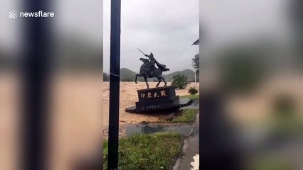 A statue in China is washed away by typhoon Lekima