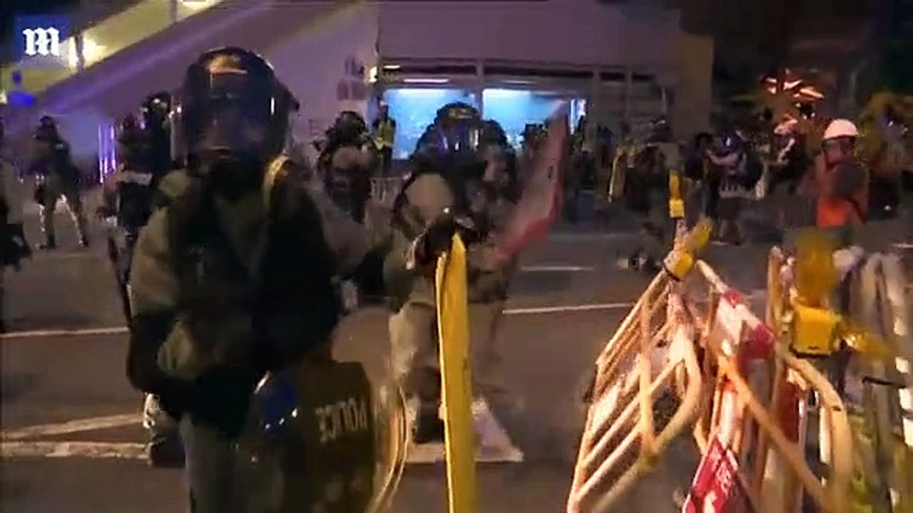 Riot police clear barricades and fire tear gas at Hong Kong protestors