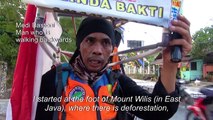 Indonesian man walking in reverse to save forests
