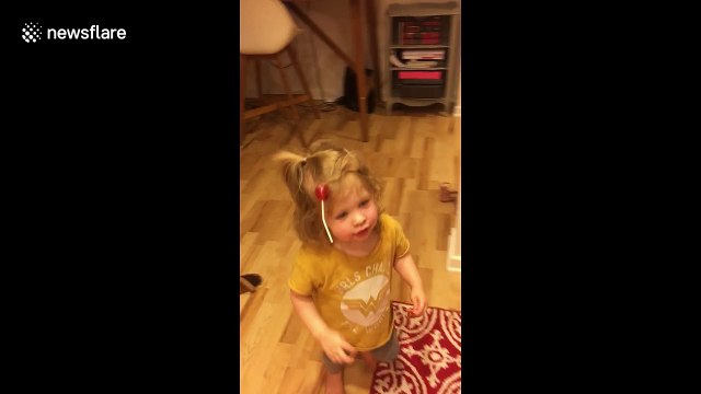 Tricked by treat! Adorable little girl baffled by lollipop stuck to hair after first Halloween
