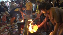 Hong Kong police fire tear gas at protesters burning offerings to mark Hungry Ghost Festival outside Sham Shui Po Police Station