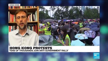 Hong Kong protesters stay peaceful as China keeps close