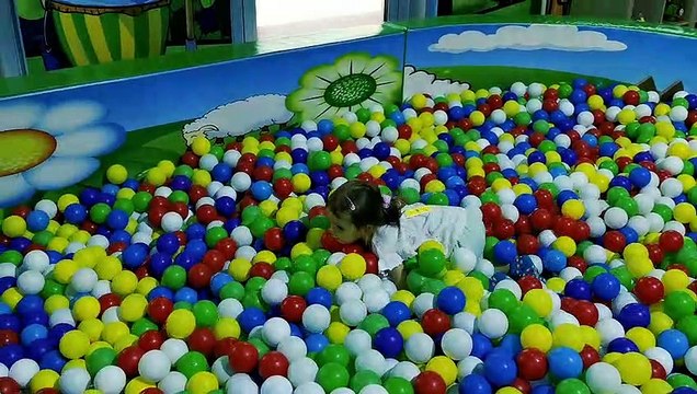 Little Mia on kids playground playing on slide and playing kitchen. Kids entertainment