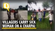 Villagers Carry Sick Lady on Cot Across River For Lack of Roads