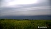Dramatic shelf cloud completely covers the sky ahead of thunderstorm