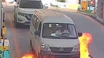 Minibus driver escapes through window after vehicle catches fire at petrol station in China