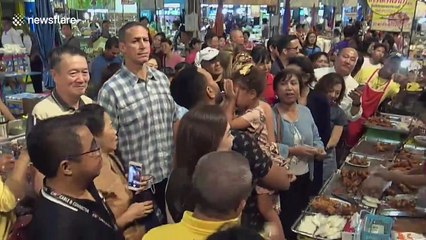 John Legend and Chrissy Teigen walk around Thai street food market