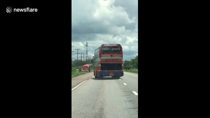 Broken bus drives diagonally on Thai motorway