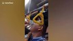Bus conductor in the Philippines dubbed 'Spider-man' as he climbs over passengers' heads to collect fares