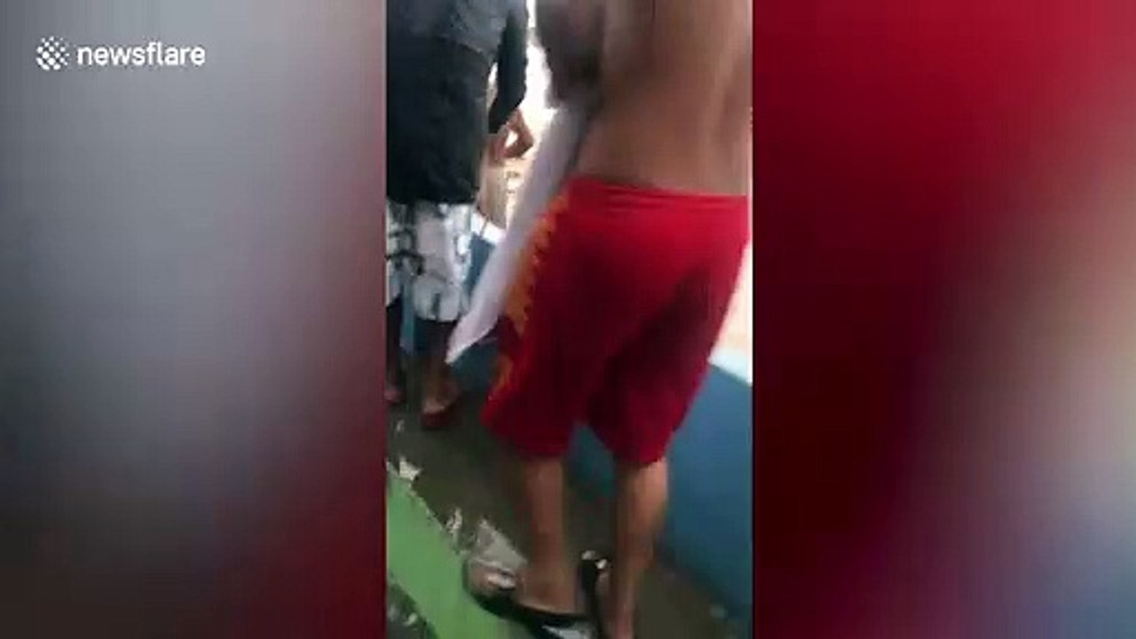 Locals battle to save drowning buffalo as Tropical Storm Bailu hits Philippines