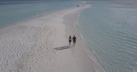 4k Couple Walking on a Beach Filmed with a Drone