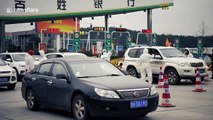 Workers in protective clothing check drivers’ temperatures on last day of Chinese New Year’s holidays