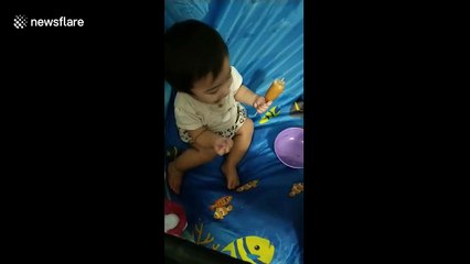 Mine! Baby in California tries corn dog for first time and won't share