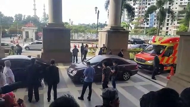 Rosmah arrives in court, accompanied by ambulance